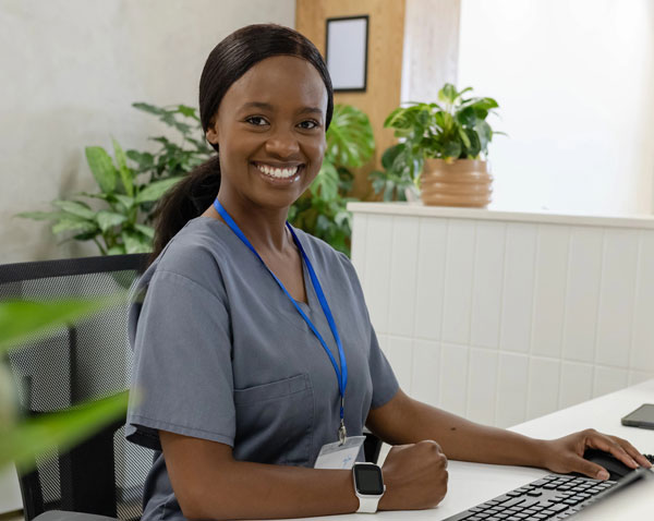 medical receptionist at computer